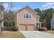 Charming two-story home with a well-manicured lawn and a two-car garage at 2240 Arnold Mill Nw Rd, Lawrenceville, GA 30044