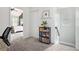 Upstairs hallway featuring a bookshelf, a view into a bedroom, and stairs to the next level at 2240 Arnold Mill Nw Rd, Lawrenceville, GA 30044