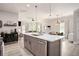 Kitchen island featuring modern appliances, barstool seating, and an open floor plan to the dining room and living room at 2240 Arnold Mill Nw Rd, Lawrenceville, GA 30044