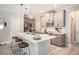 Well-lit kitchen features gray cabinets, marble countertops, stainless steel appliances, and pendant lighting at 2240 Arnold Mill Nw Rd, Lawrenceville, GA 30044
