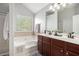 Spa-like main bathroom with double vanity, soaking tub, and separate shower at 2240 Arnold Mill Nw Rd, Lawrenceville, GA 30044