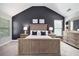 Spacious main bedroom with a dark accent wall, large dresser, and ample natural light at 2240 Arnold Mill Nw Rd, Lawrenceville, GA 30044
