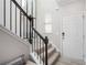 Elegant staircase featuring black railings and a comfortable landing bench with pillow at 2240 Arnold Mill Nw Rd, Lawrenceville, GA 30044