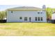 Back of the home featuring a big yard, siding exterior, windows and door leading to the outside at 3903 Cain Mill Dr, Lithonia, GA 30038