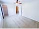 Bedroom with neutral walls, carpet, ceiling fan, and doors leading to closets and other rooms at 3903 Cain Mill Dr, Lithonia, GA 30038