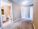 Bedroom with plush carpet and two doors, one leading to the bathroom, with tile flooring at 3903 Cain Mill Dr, Lithonia, GA 30038