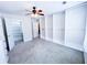 Carpeted bedroom showcasing custom closet organizers, windows for natural light, and multiple doorways at 3903 Cain Mill Dr, Lithonia, GA 30038