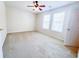 Bright bedroom with neutral walls, carpet, ceiling fan, and natural light from the double windows at 3903 Cain Mill Dr, Lithonia, GA 30038
