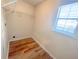 Small walk-in closet with a window and built in shelves and laminate wood floors at 3903 Cain Mill Dr, Lithonia, GA 30038