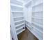 Walk-in closet featuring built-in shelving units and hanging rods for organized storage at 3903 Cain Mill Dr, Lithonia, GA 30038