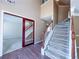 Bright foyer with a staircase and entry to the living room featuring wood floors and fresh paint at 3903 Cain Mill Dr, Lithonia, GA 30038