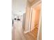 Hallway with wood floors leading to living area with fireplace, with a half-bath adjacent to the hallway entrance at 3903 Cain Mill Dr, Lithonia, GA 30038