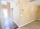 Hallway leading to the front door and other rooms, featuring wood floors and natural light at 3903 Cain Mill Dr, Lithonia, GA 30038