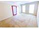 Spacious living room with windows and neutral carpet offers a bright and inviting atmosphere at 3903 Cain Mill Dr, Lithonia, GA 30038