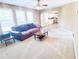 Bright living room featuring plush carpet, ceiling fan and large windows that opens to the kitchen at 3903 Cain Mill Dr, Lithonia, GA 30038