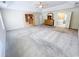 This main bedroom features a ceiling fan, beige carpet, and an en suite bathroom at 3903 Cain Mill Dr, Lithonia, GA 30038