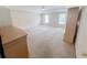 Spacious main bedroom featuring large windows, plush carpet, and a ceiling fan at 3903 Cain Mill Dr, Lithonia, GA 30038