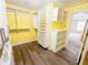 Bright walk-in closet with laminate flooring and custom shelving for optimal organization at 3903 Cain Mill Dr, Lithonia, GA 30038