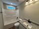 Bathroom featuring a bathtub and shower combination, modern fixtures, and granite countertop sink at 482 West Ave, Bowdon, GA 30108