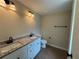 Bathroom featuring double vanity sinks, modern fixtures, and a separate toilet at 482 West Ave, Bowdon, GA 30108