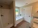 Bathroom with shower and separate tub next to the window for natural lighting at 482 West Ave, Bowdon, GA 30108