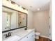 Bathroom features double sinks with granite countertops and a walk-in shower at 482 West Ave, Bowdon, GA 30108