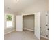 Bedroom boasts natural light, a closet with an open door, and neutral carpet flooring at 482 West Ave, Bowdon, GA 30108