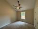Bedroom with carpet, ceiling fan, and a view to the yard from the window at 482 West Ave, Bowdon, GA 30108