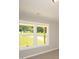 The bedroom features large windows which let in natural light and offer a view of the trees outside at 482 West Ave, Bowdon, GA 30108
