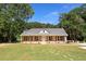 Charming single-story home with stone accents, a well-manicured lawn, and a welcoming front porch at 482 West Ave, Bowdon, GA 30108