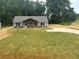 New construction home featuring a freshly installed lawn and a charming covered porch at 482 West Ave, Bowdon, GA 30108