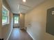 Bright hallway with wood floors, a rear entry door, and hookups for a washer and dryer at 482 West Ave, Bowdon, GA 30108