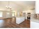 Open concept featuring bright kitchen with a granite island and hardwood floors at 482 West Ave, Bowdon, GA 30108