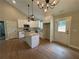 Modern kitchen features stainless steel appliances, granite countertops, and stylish pendant lighting at 482 West Ave, Bowdon, GA 30108