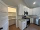 Well-lit kitchen with granite countertops, stainless appliances, and ample cabinet storage at 482 West Ave, Bowdon, GA 30108
