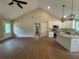 Open concept living space with vaulted ceiling, hardwood floors, and adjacent kitchen at 482 West Ave, Bowdon, GA 30108