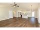 This bright open concept living space features wood floors and white kitchen with stainless steel appliances at 482 West Ave, Bowdon, GA 30108