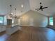 Open-concept living space with hardwood floors and modern lighting fixtures at 482 West Ave, Bowdon, GA 30108