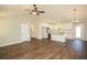 Open concept living space boasts wood floors and bright kitchen with island and stainless steel appliances at 482 West Ave, Bowdon, GA 30108