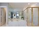 A luxurious bathroom with a soaking tub, a gold-trimmed glass shower and a white vanity at , Atlanta, GA 30305