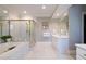 Bright bathroom with marble tile, a shower with gold trim, and a double vanity at , Atlanta, GA 30305