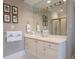 Well-lit bathroom vanity area with white cabinets, gold fixtures, and a large mirror at , Atlanta, GA 30305