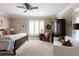 Bright bedroom featuring a ceiling fan, white sofa, and natural light from shuttered windows at , Atlanta, GA 30305