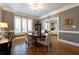 Elegant dining room with hardwood floors, wainscoting, plantation shutters, and views to the living room at , Atlanta, GA 30305