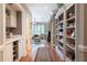Elegant hallway featuring built-in bookshelves and wine storage, leading to the living area at , Atlanta, GA 30305