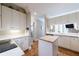 Modern kitchen with white cabinetry, hardwood floors, an island, and stainless steel appliances at , Atlanta, GA 30305