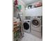 Functional laundry room featuring a washer, dryer, storage shelves, and tiled floor at , Atlanta, GA 30305