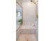 Walk-in shower stall featuring marble walls, a built-in bench, and gold fixtures at , Atlanta, GA 30305
