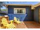 View of a back porch with wooden deck and yellow Adirondack chairs offering a relaxing outdoor space at 1514 Rogers Sw Ave, Atlanta, GA 30310