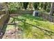 Backyard with a storage shed and a well-maintained lawn surrounded by a privacy fence and mature trees at 1514 Rogers Sw Ave, Atlanta, GA 30310